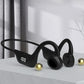 Black wireless earbuds with a digital display on a light surface.