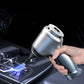 Hand holding a car air freshener device with a dark car interior background