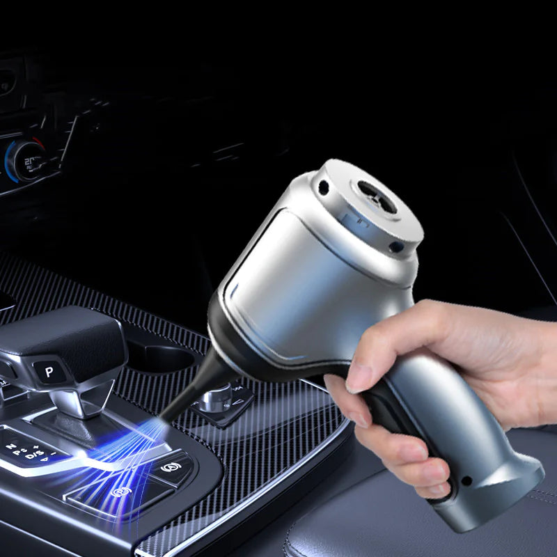 Hand holding a car air freshener device with a dark car interior background