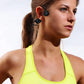 Woman wearing wireless earbuds with a neutral background